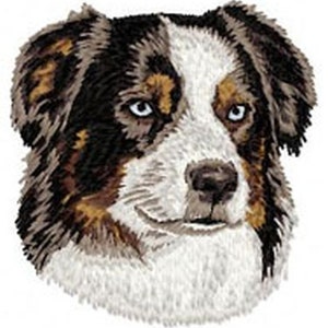 May include: Embroidered portrait of an Australian Shepherd dog. The dog has a white face with brown and black markings around the eyes and ears. The dog's eyes are a striking blue color. The image is a close-up of the dog's head.