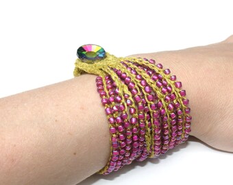 May include: A multi-strand bracelet with pink and gold beads and a colorful rhinestone button closure.