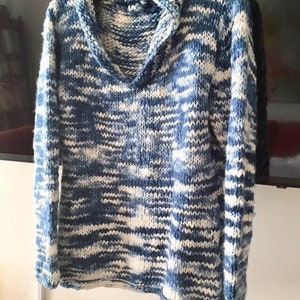 May include: A blue and white striped hooded sweater with a v-neck. The sweater is made of a soft, knitted fabric.