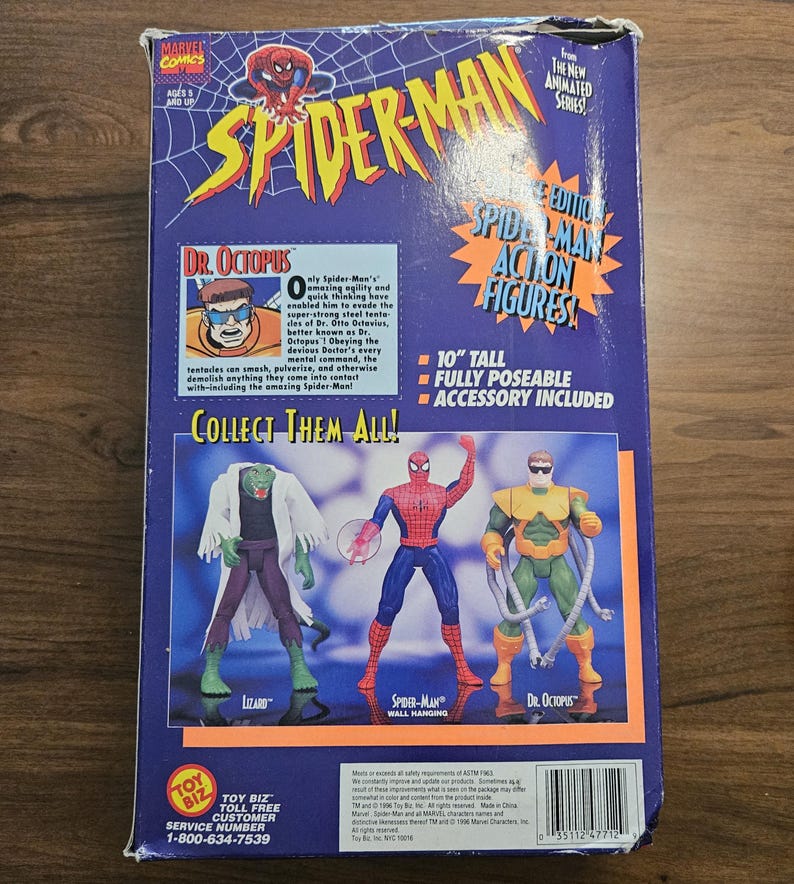 以下が含まれることがあります： ヴィンテージのスパイダーマンのアクションフィギュアの箱。箱にはスパイダーマンのロゴと、スパイダーマン、ドクター・オクトパス、リザードのアクションフィギュアの画像が描かれています。箱の高さは25.4cmで、アクセサリーが含まれています。