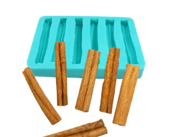 Puede incluir: Un molde de silicona turquesa con seis cavidades rectangulares, junto con varios palitos de canela. Los palitos de canela son de varias longitudes y tonos marrones. El molde está diseñado para crear artículos en forma de palito de canela.