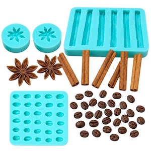 May include: An assortment of teal silicone molds for crafting, alongside real cinnamon sticks, star anise, and coffee beans. The molds are designed in various shapes, including starbursts, sticks, and coffee beans, perfect for baking or crafting.