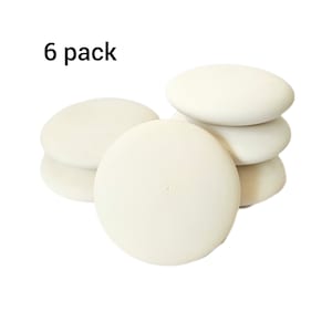May include: A pack of six white round chalk erasers. The erasers are stacked on top of each other. The text "6 pack" is visible in the top left corner of the image.