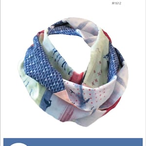 May include: A multi-colored Kozy Q Scarf with a patchwork design. The scarf is made of various fabrics in shades of blue, red, and white. The scarf is available in three sizes: 60 inches, 72 inches, and 84 inches long.