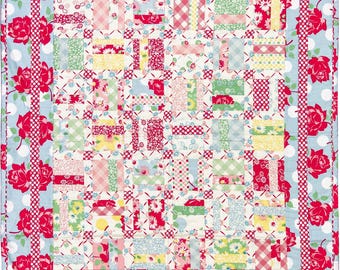 Beautiful crib quilt in reds, blues, greens and yellows based on the pattern Woven In