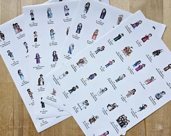 Może przedstawiać: Kilka arkuszy papieru z kolorowymi ilustracjami świętych. Każdy święty jest przedstawiony w innym stroju, z imionami i numerami poniżej. Arkusze ułożone są na jasnobrązowej drewnianej powierzchni.