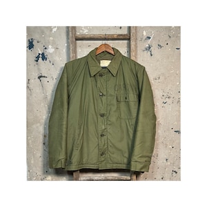 May include: A green military-style jacket with a button closure and a patch that reads "CARO" on the left chest.