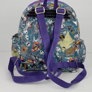 May include: A purple and blue backpack with a Nightmare Before Christmas print. The backpack has a large compartment and two adjustable straps.