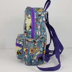 May include: A small blue and purple backpack with a print of characters from the Nightmare Before Christmas. The backpack has a zippered pocket on the front and adjustable straps.