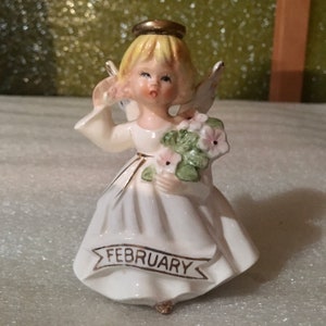 Vintage Hand Painted February Girl Angel Holding a Bouquet of Flowers as well as a Single Flower Figurine
