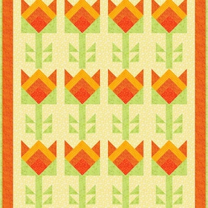 May include: A quilt block with a repeating pattern of orange, yellow, and green tulips on a white background. The quilt block has a red border.