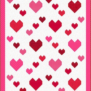 May include: A white quilt with a pink border and a pattern of red and pink hearts. The hearts are of different sizes and are arranged in a random pattern.