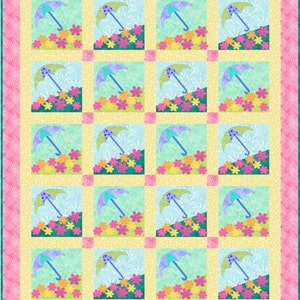 May include: A colorful quilt featuring a repeating pattern of umbrellas and flowers. Each square showcases a blue umbrella over a bed of pink, yellow, and orange flowers against a light blue background. The quilt has a pink border.