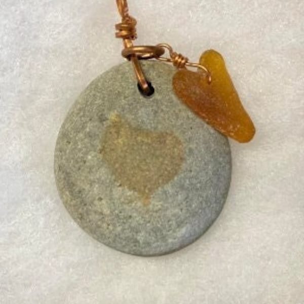 Round Rock pendant with heart marking hanging with brown Seaglass heart on Copper wire, with wire-wrapped loop on Copper ball chain.