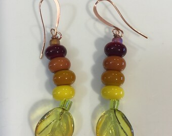 Bright Yellow and browns Lampwork beaded dangly earrings on shiny glass leaf headpins now on our handmade earwires.