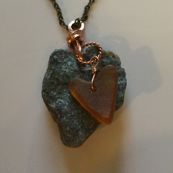 Amazing heart Rock wire wrapped with square copper wire and manmade amber seaglass heart hanging on copper chain of your choosing.