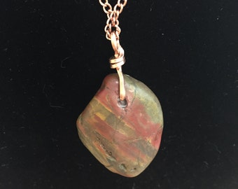 Rock Pendant of Smooth Jasper from the East Middlebury River in Vermont  wire wrapped with copper wire and hanging on a copper chain.