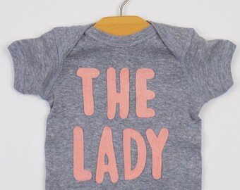 The Lady Baby Bodysuit: Heather Gray Cotton Onesie, Peach Applique