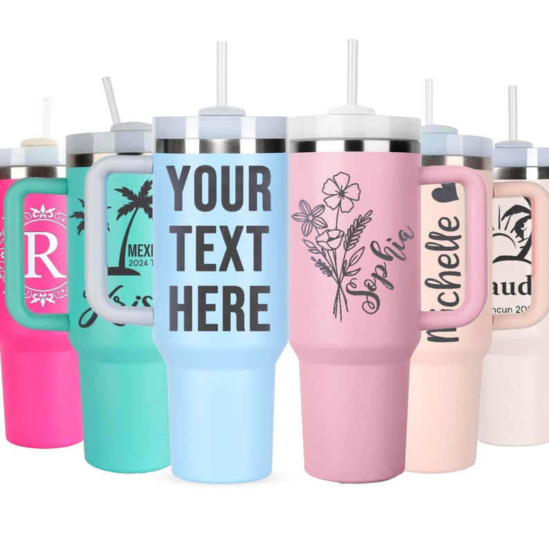 Colorful lineup of 40oz tumblers engraved with names and floral designs — personalized Stanley-style cups with handles and straws for custom gifts.