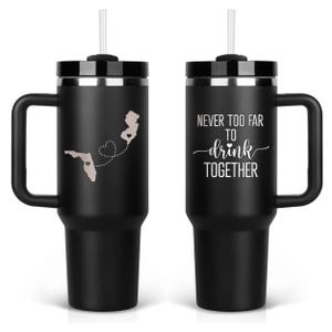 Pair of black engraved tumblers — front and back engraving shown with travel quote “Never too far to drink together.” Two sides engraving