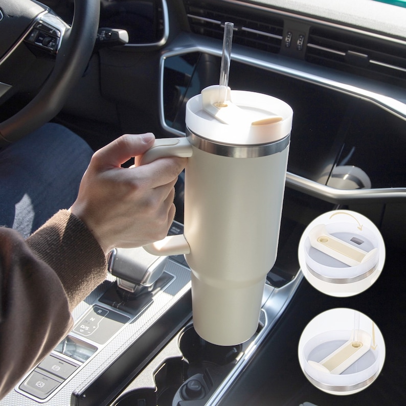 Tumbler in car cup holder — stainless steel insulated mug with handle and straw, ideal for daily travel or work use.