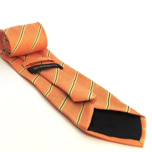 May include: A striped orange and yellow tie with a black label that says "SORENTO".