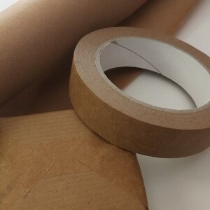May include: A roll of brown kraft paper, a roll of brown packing tape, and a small brown cardboard box.