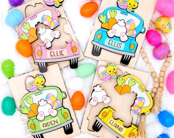 May include: Four wooden Easter puzzles featuring a bunny in a truck with a basket of eggs. Each puzzle has a different color truck and the names Ellie, Ellis, Aiden, and Elaina are written on the trucks.
