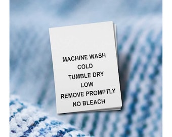 May include: White care label with black text instructions: Machine Wash Cold, Tumble Dry Low, Remove Promptly, No Bleach.