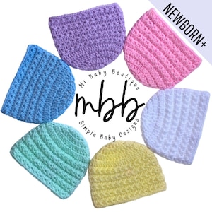 May include: Six crocheted baby hats in different colors, including light blue, lavender, pink, white, light green, and yellow. The hats are arranged in a circle with the text "Mi Baby Boutique mbhb Simple Baby Designs" in the center.
