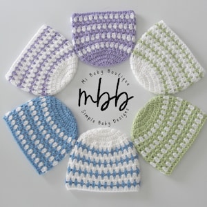 May include: Six crocheted baby hats in various colours, including purple, green, blue, and white. The hats have a simple, striped pattern. The hats are arranged in a circle around a logo that says "Mi Baby Boutique mbhb Simple Baby Designs".