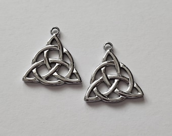 May include: Two silver Celtic knot pendants in the shape of a triangle. The knots are intricately woven and have a smooth, polished finish.