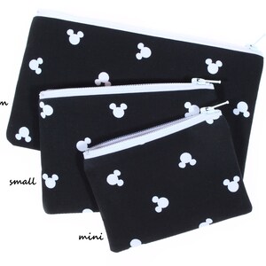 May include: Three black zippered pouches with white Mickey Mouse silhouettes printed on them. The pouches are nested inside each other, with the largest pouch labeled "medium", the middle pouch labeled "small", and the smallest pouch labeled "mini".
