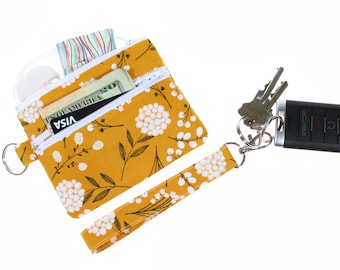 Cartera con llavero floral: bolsa hecha a mano con doble cremallera y correa para la muñeca.