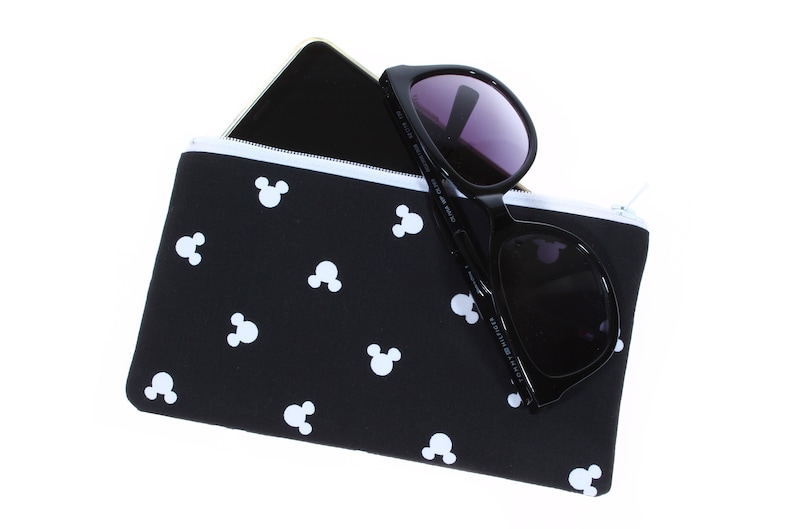 May include: Black zippered pouch with a white Mickey Mouse pattern. The pouch is filled with a black smartphone and sunglasses.