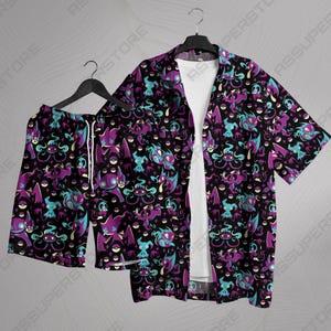 May include: A purple and blue patterned button-up shirt and matching shorts featuring a repeating design of a cartoon ghost-like creature.