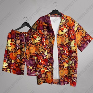 May include: A red and orange patterned button-up shirt and matching shorts featuring a cartoon character design. The shirt has short sleeves and a collared neckline. The shorts have an elastic waistband and a drawstring.