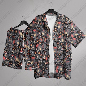 May include: A black and red patterned shirt and shorts set featuring a cartoon character. The shirt has short sleeves and a collared neckline. The shorts have an elastic waistband.