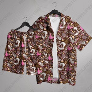 May include: A matching brown short-sleeved shirt and shorts set. The set features a repeating pattern of cartoon squirrels, pink accents, and various food items. The shirt is open, revealing a white t-shirt underneath. The shorts have a drawstring.