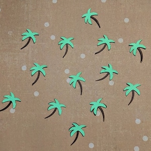 May include: A brown background with white dots and 14 green palm trees with black trunks.