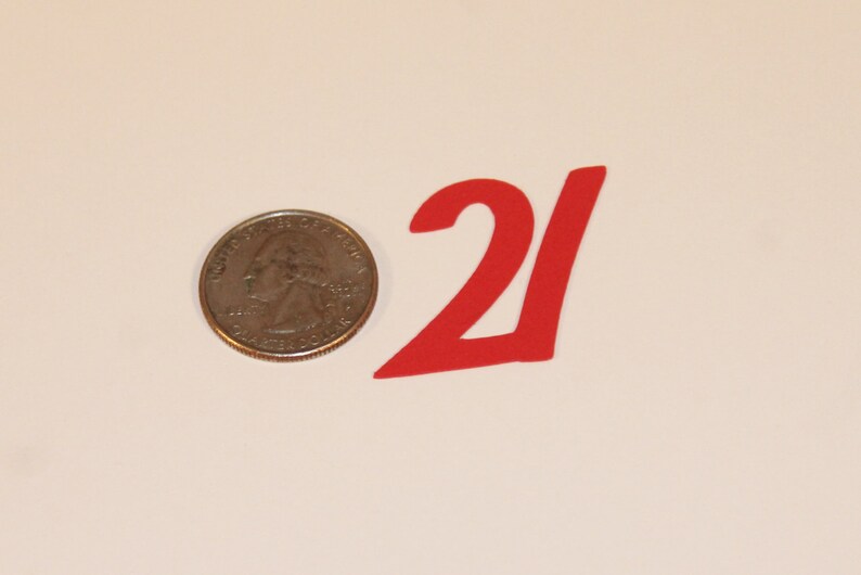 May include: Red paper number 21, approximately the size of a US quarter.