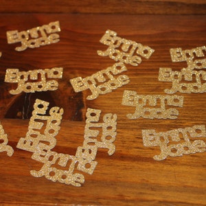 May include: Gold glitter confetti with the name "Emma Jade" repeated on each piece.