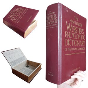 May include: A burgundy-colored "The New Lexicon Webster's Encyclopedic Dictionary" book. The book's cover features gold lettering and the words "Deluxe Edition." One image shows the book open, revealing a hollowed-out interior.