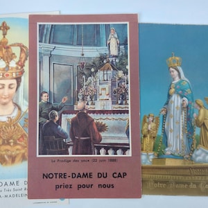 May include: A selection of vintage religious cards depicting the Virgin Mary. The cards show the Virgin Mary wearing a crown, in a church, and with angels. The text on the cards includes "Notre Dame" and "Priez pour nous".
