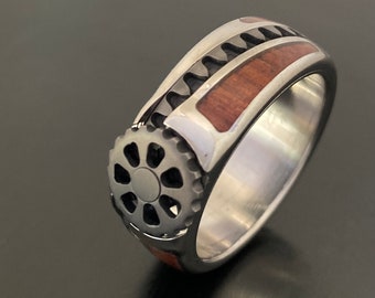 The Watchman - A titanium gear wheel wearable machine combined with polished wood. A ring that combines precision motion with art.