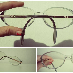 May include: Two pairs of clear plastic eyeglasses with thin metal arms. The first pair has a dark gray bridge and the second pair has a silver bridge.
