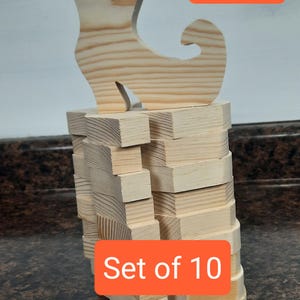 May include: Set of 10 unfinished wooden witch shoe shapes, each measuring 5 1/4 inches tall.