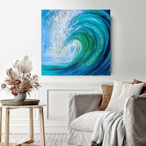May include: A painting of a large blue wave crashing with white foam. The wave is painted in shades of blue and green. The text "Love the Ocean" is written in white on the wave.