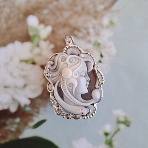 Silver pendant with girl&#39;s face cameo.