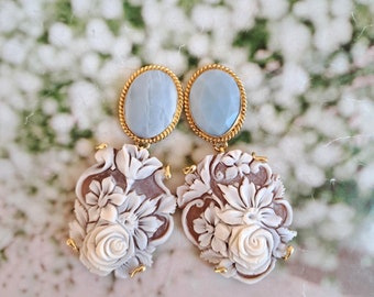 Cameo earrings with flowers and blue stones.